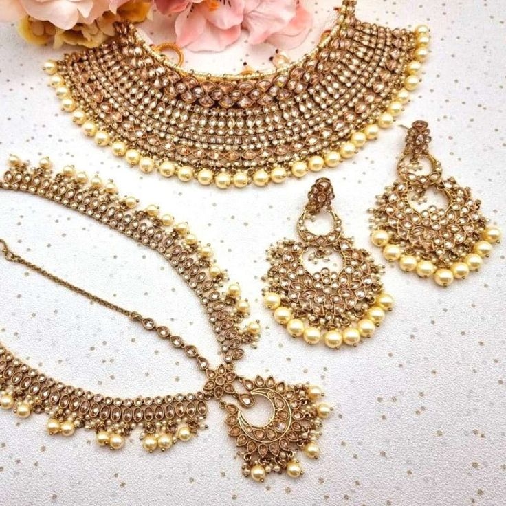 This Necklace Bridal Set is pure bliss. When you are looking for Bridal Jewelry for your Big Day you won't find anything better than this ethereal beauty. This choker necklace is made with brass as the base metal. Finished to eternal perfection with Stonework, Stones, beads work, and small white pearls detailing. This gorgeous piece is a showstopper. You don't need to look for anything else if you have this. even more beautiful in real! You will surely turn some heads when you will wear this one Wedding Necklaces With Latkans For Eid, Wedding Jewelry For Eid With Tilla Detail, Gold Bridal Accessories For Festivals, Hand Set Gold Bollywood Bridal Accessories, Bollywood Style Gold Bridal Accessories With Hand Set Details, Bollywood Style Tilla Necklaces For Marriage, Gold Sets With Pallu For Marriage, Gold Jewelry Sets For Wedding And Eid, Gold Festive Sets For Marriage