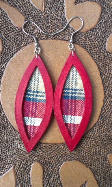 two pairs of red and white plaid leather earrings with silver hooks on a brown background