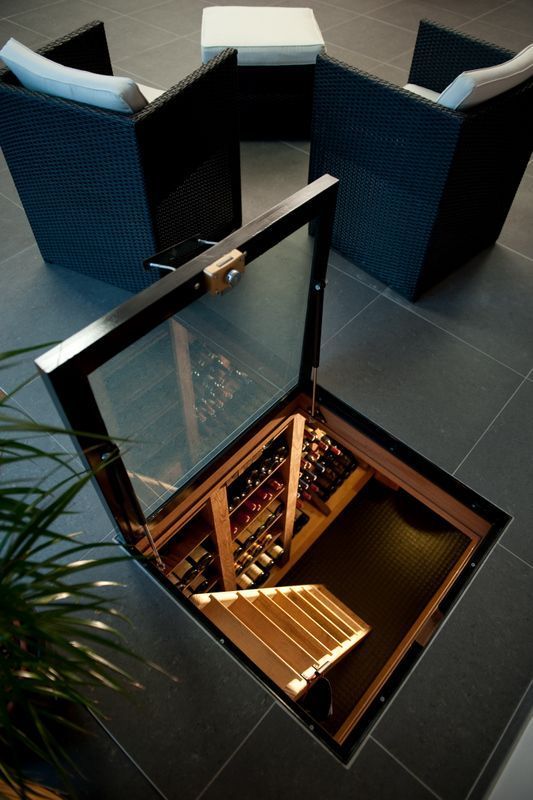 an overhead view of a wine cellar in the middle of a room with wicker furniture