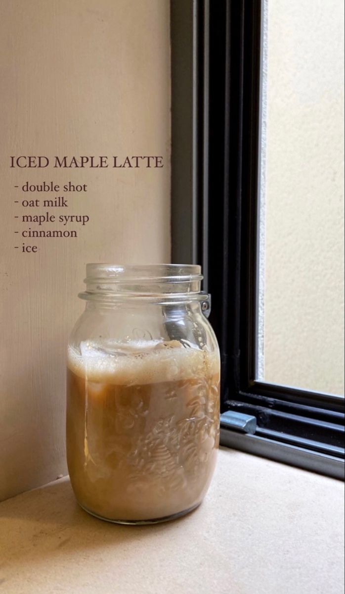 an iced maple latte in a jar next to a window