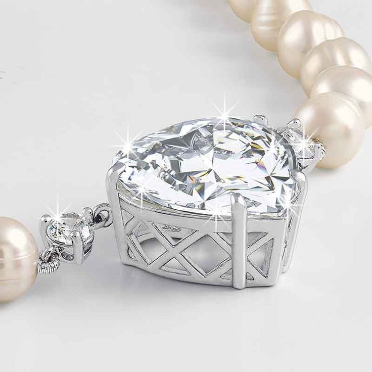 Features a spectacular heart-shaped Diamonisse simulated diamond, a facet-by-facet homage to the original — in a custom-designed setting. The centerstone is embraced by two fiery Diamonisse and is suspended from a strand of luminous white cultured pearls for a supremely elegant e?ect. Danbury Mint, Pearl Necklaces, Cultured Pearls, Bracelet Watch, Heart Shapes, Mint, Engagement Rings, Necklaces, The Originals