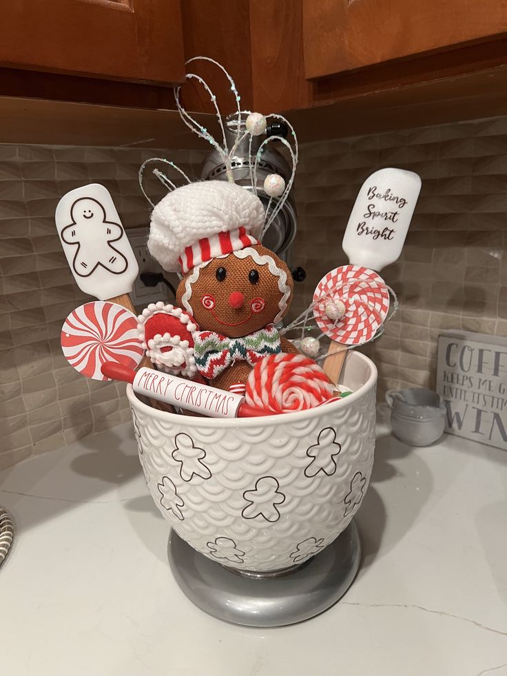 a gingerbread man in a bowl with candy canes and lollipops