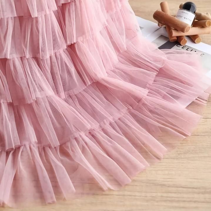 Discover the Charm of Elegance Step into a world of grace and style with our Elegant Spring/Summer Tulle Skirt. Designed for the modern woman who appreciates a blend of casual sophistication and timeless elegance, this skirt is perfect for a variety of occasions. Whether you're attending a casual gathering or dressing up for a more formal event, this skirt will elevate your wardrobe with its chic and versatile design. Product Features Material: High-quality polyester and voile blend for durability and a soft feel Style: Casual yet chic, with a solid pattern that pairs easily with any top Elasticity: Slight stretch to fit your body comfortably Season: Ideal for spring and summer wear Waistline: Empire cut to accentuate your figure Fit Type: Regular fit ensuring freedom of movement Silhouett Spring Flowy Tulle Pleated Skirt, Spring Tulle Pleated Flowy Skirt, Voluminous Summer Pleated Skirt For Parties, Voluminous Ruffled Maxi Skirt For Summer, Non-stretch Tiered Skirt For Party, Non-stretch Tiered Party Skirt, Elegant Summer Maxi Skirt With Ruffles, Chic Summer Tiered Pleated Skirt, Spring Flared Tulle Mini Skirt