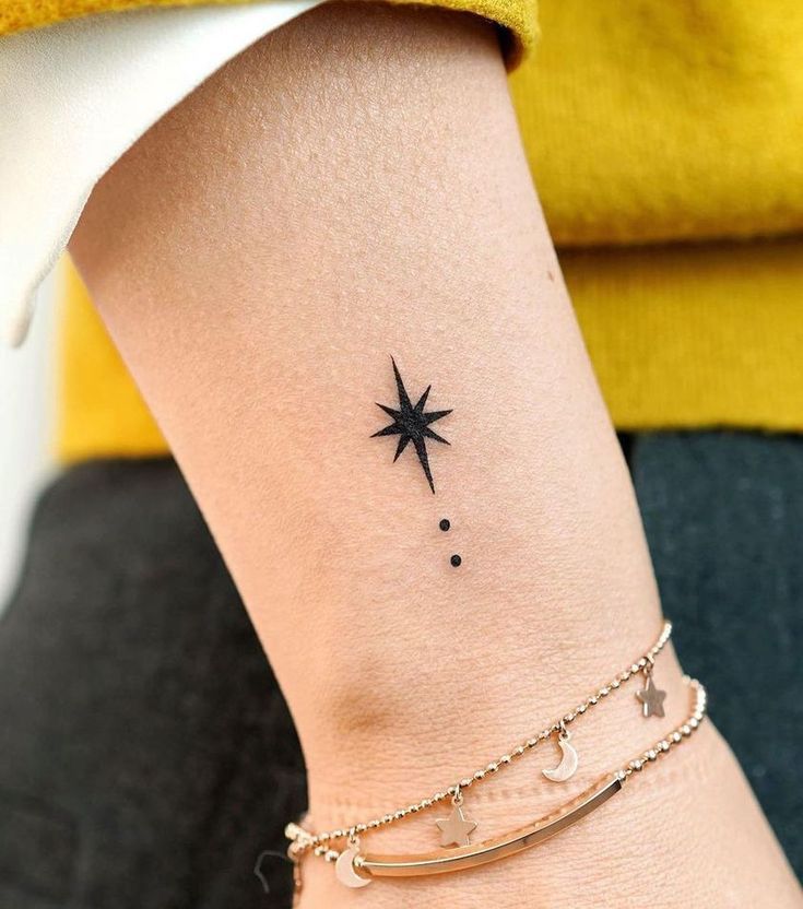 a small star and moon tattoo on the left side of the ankle, with two stars above it