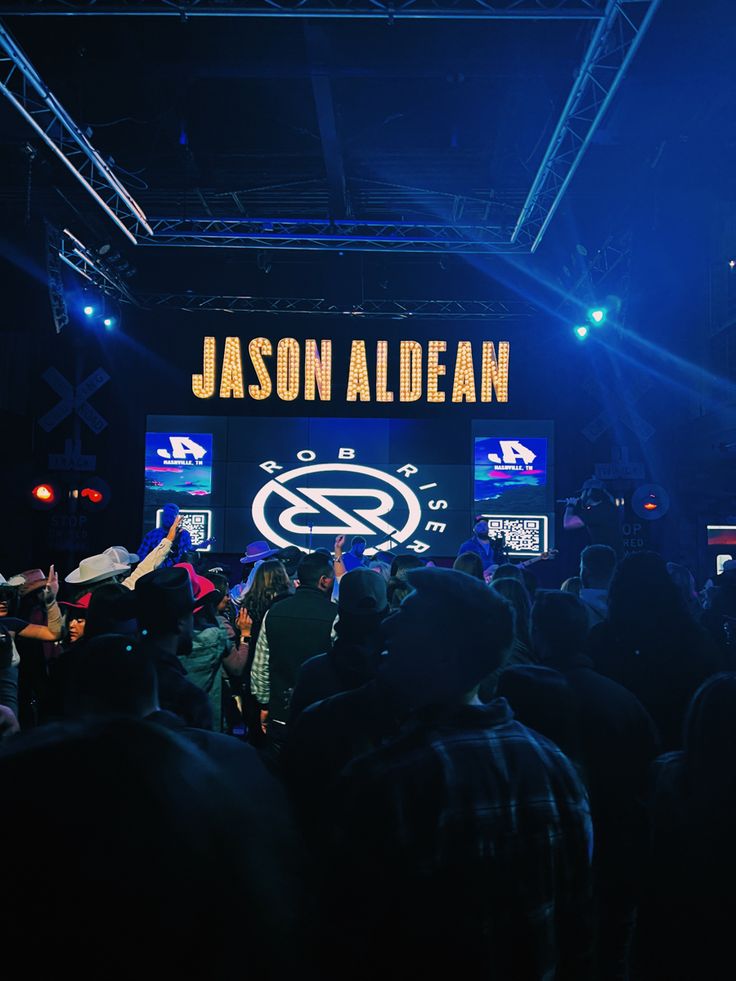 a group of people standing in front of a stage