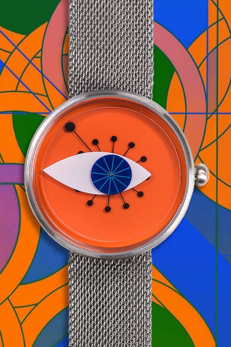 a watch with an eye on the face is shown in front of colorful circles and lines