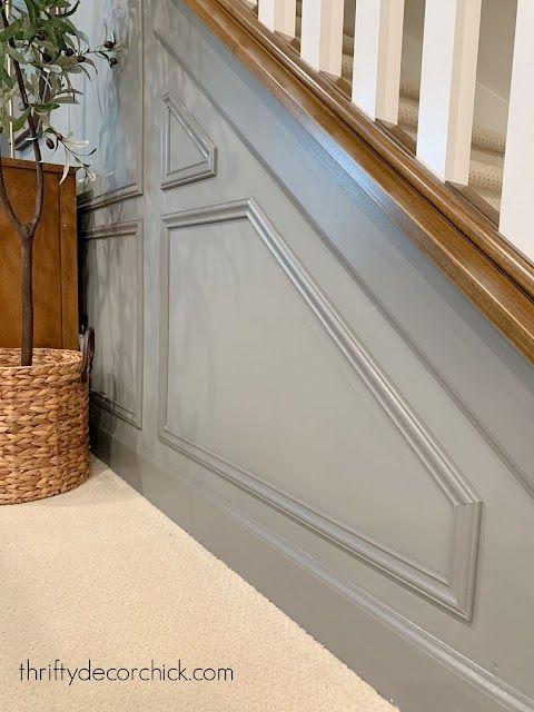 a potted plant sitting next to a wooden banister