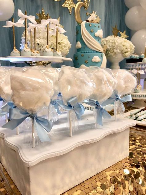 there are many candy lollipops on display in this room with blue and white decorations