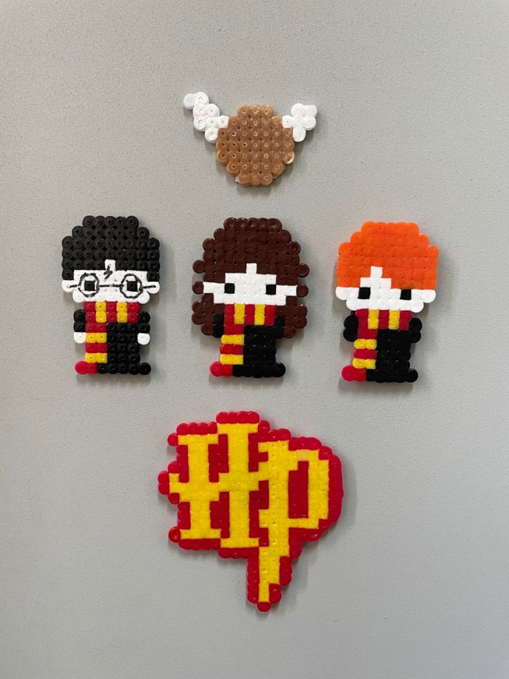 four lego harry potter character magnets on a gray surface