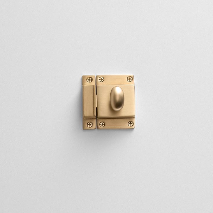 a gold door handle on a white wall