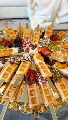 waffles and fruit arranged on a gold platter