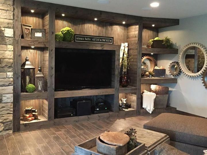 a living room filled with furniture and a flat screen tv on top of a wooden shelf