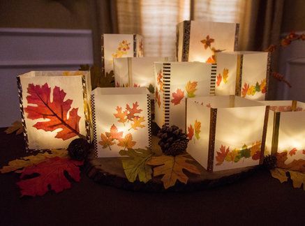 small cards with autumn leaves on them are sitting on a table in front of a window