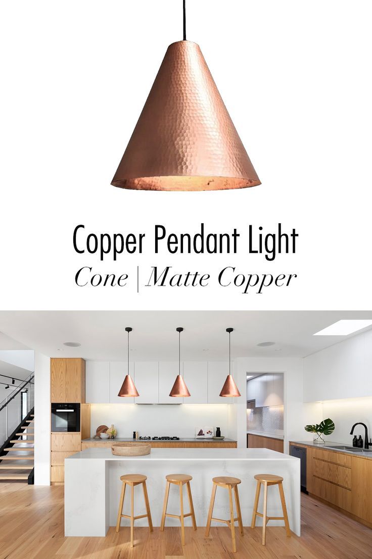 the copper pendant light is hanging over a kitchen island