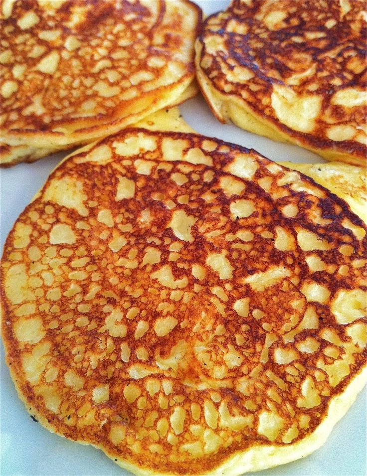 four pancakes are arranged on a white plate