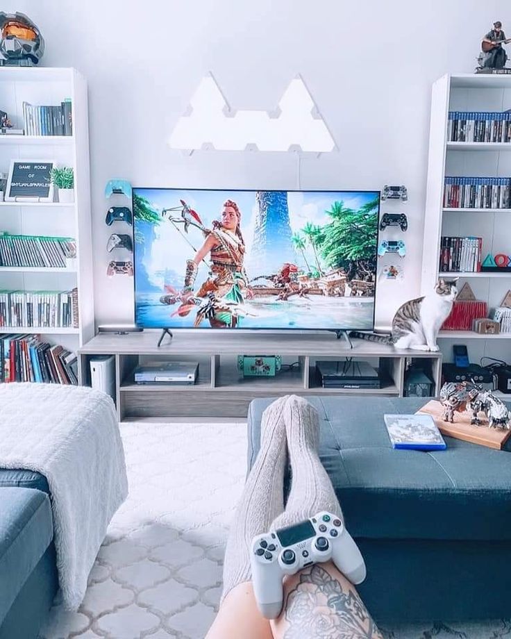 a person laying on the floor in front of a tv with video game remotes