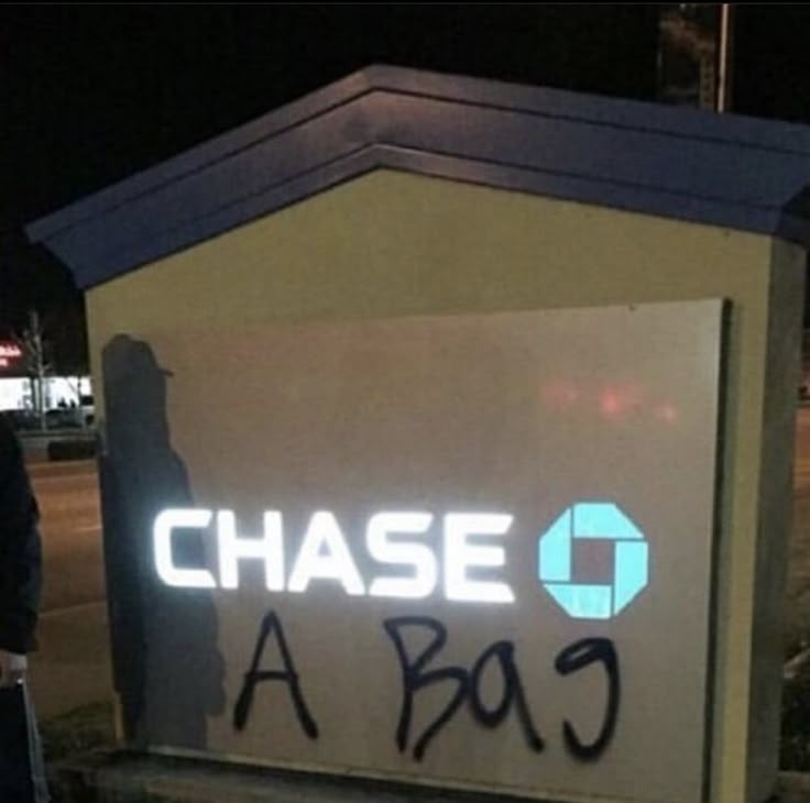 a sign that says chase c is in front of a building with graffiti on it