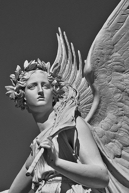 an angel statue is shown in black and white