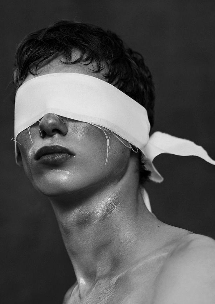 black and white photograph of man with blindfold