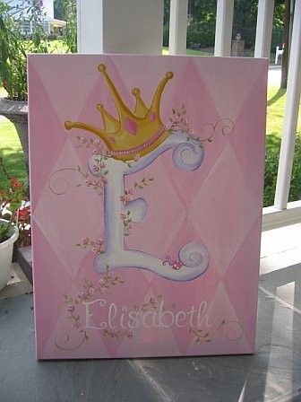 a pink birthday card with a gold crown on the letter e in front of some flowers