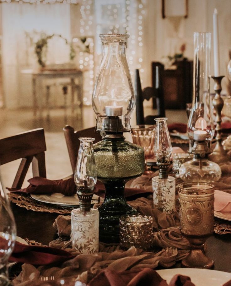 the table is set with glasses and candles