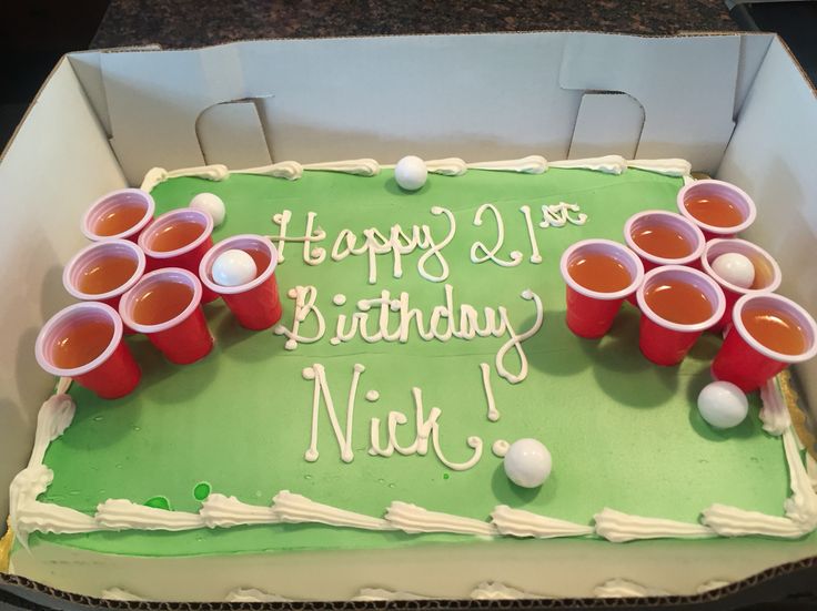 a green sheet cake with red cups on it