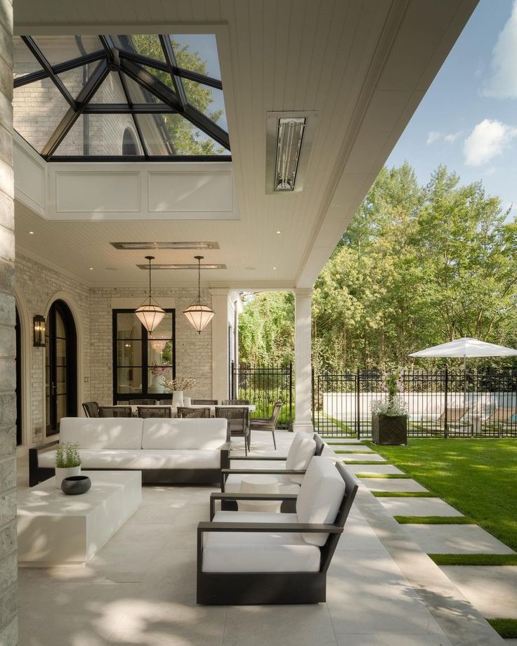 an outdoor living area with couches and tables