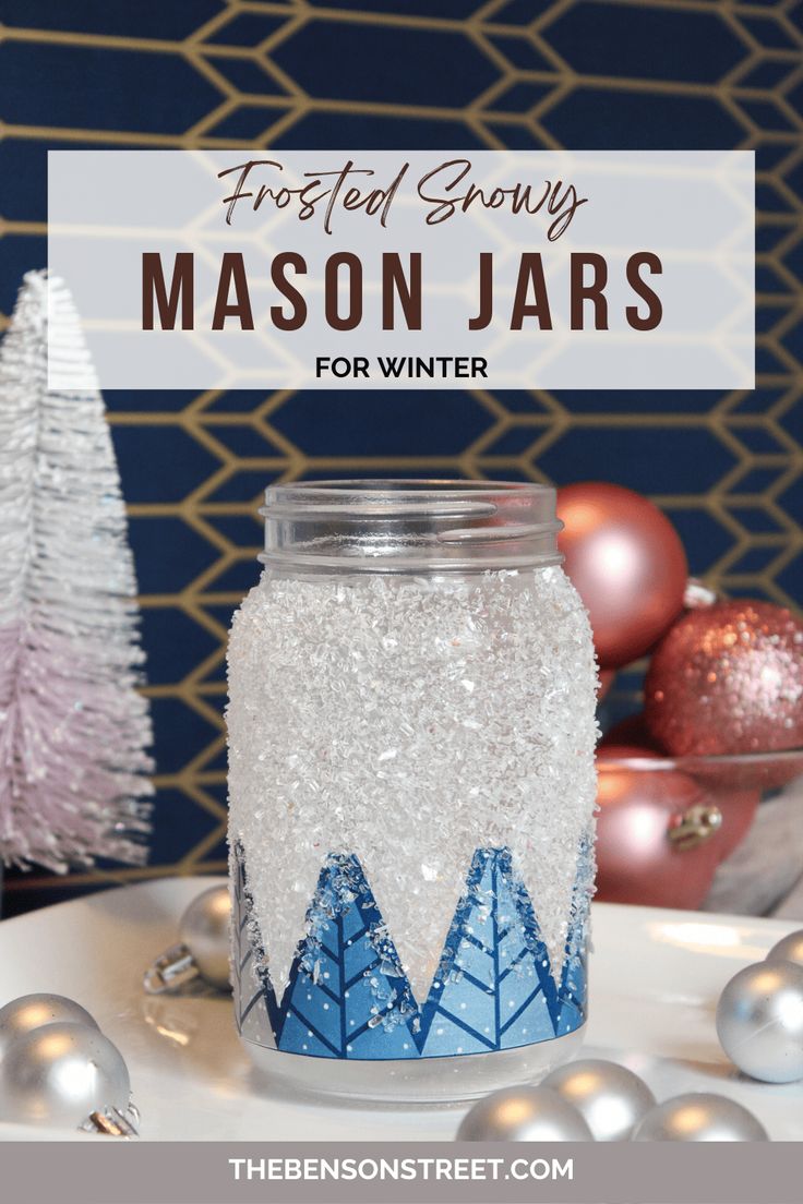 a mason jar decorated with snow and trees