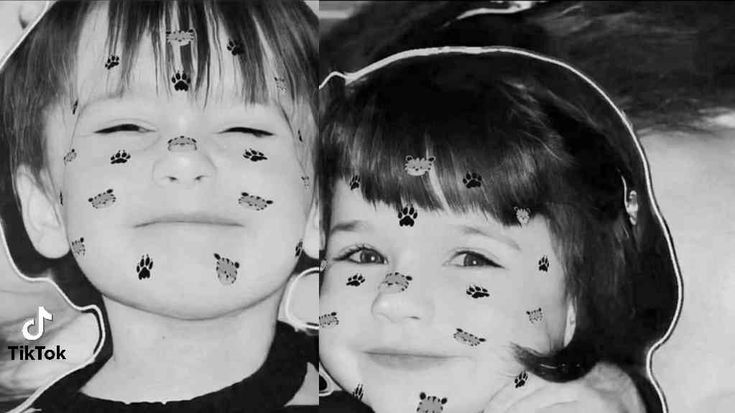 two young children with their faces covered in cat prints