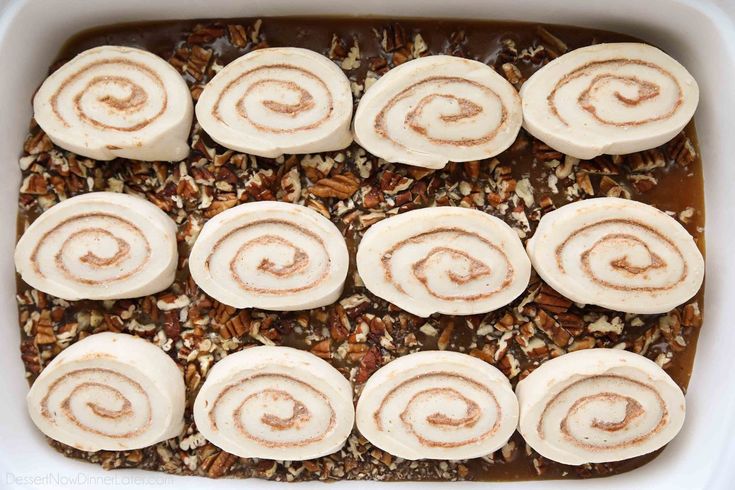 a casserole dish filled with cinnamon rolls and granola toppings on top