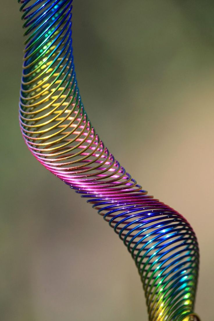 a multicolored spiral like object hanging from a hook