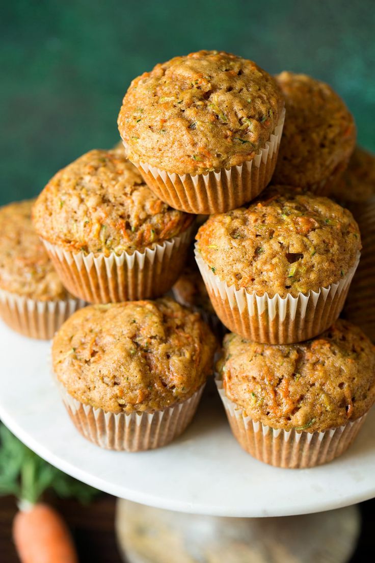 a stack of carrot muffins sitting on top of a white plate