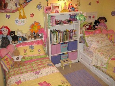 two small children's beds in a room with yellow walls