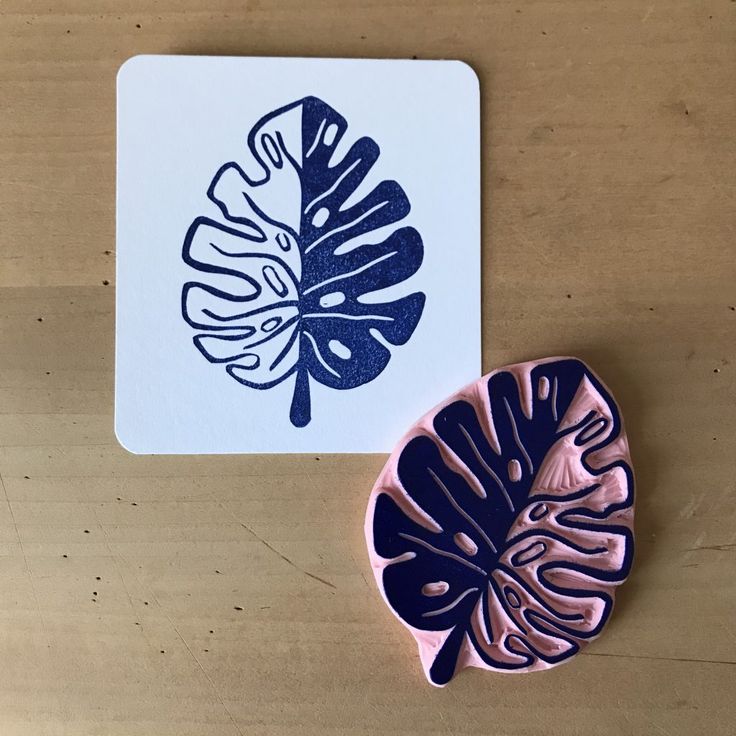 a rubber stamp with a leaf design on it next to a rubber coaster that has been placed on a wooden surface