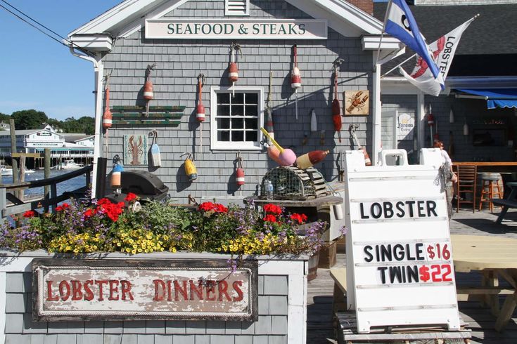 lobsters and other items are on display in front of a seafood restaurant that is open for business