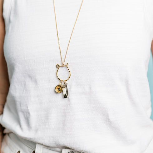 Tiny compass, bone handled knife, and gold four leaf clover lucky charm on a charm holder. Open up the charm holder and add your own special amulets to personalize this necklace. 32" chain Metal: 24kt gold-plate over brass charm holder, 14kt gold-plated clover, brass compass, bone handled knife, 18kt gold-plated chain Size: 4" L overall pendant Lobster clasp Yellow Gold Amulet Style Charm Necklaces, Everyday Amulet Round Pendant Charm Necklace, Good Luck Medallion Necklace With Charms, Everyday Locket Pendant Charm Necklace, Brass Initial Pendant Necklace With Charms, Spiritual Good Luck Necklaces With Dangling Charms, Spiritual Necklaces With Dangling Charms For Good Luck, Spiritual Good Luck Necklace With Dangling Charms, Spiritual Gold Jewelry For Everyday Use