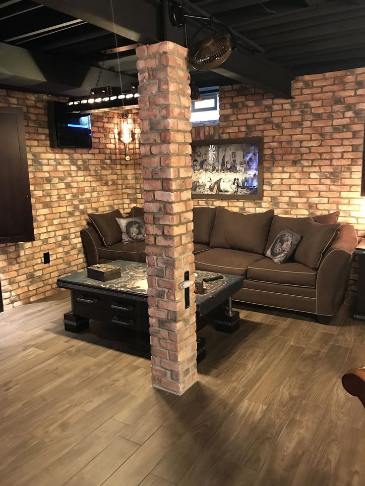 a living room filled with furniture and brick walls