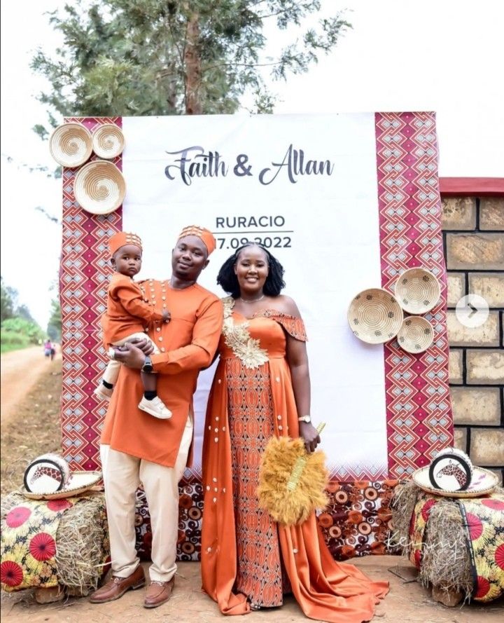 two people standing next to each other in front of a sign with the words faith & allen on it