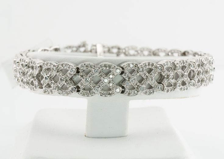 Genuine Diamond Bracelet, April Birthstone, 14K White Gold Bracelet, Everyday Bracelet, Wide Bracelet, Diamond Studded Bracelet, Geometric Bracelet. This gorgeous bracelet is finely crafted in solid 14K White Gold and set with white and fiery diamonds. The auction tag is attached. The bracelet is studded with 390 natural diamonds. These gems are SI2 to I2 clarity and HI color. The grand total diamond weight is 4.50 carats. The width of the bracelet is 3/8 inches and it is 6.75 inches long. Sturd White Diamond Bracelet In Fine Jewelry Style, White Platinum Diamond Bracelet In Fine Jewelry Style, White Diamond Bracelet With Jubilee Design, White Platinum Diamond Bracelet Fine Jewelry, White Platinum Diamond Bracelet, White Diamond Bracelet Fine Jewelry, Exquisite White Diamond Bracelet With Diamond Cut, Exquisite White Diamond Bracelet For Anniversary, White Platinum Jubilee Diamond Bracelet