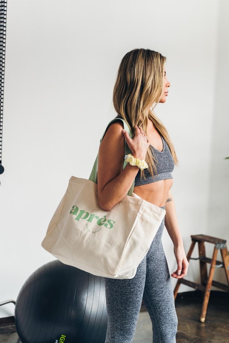 All your gear fits in here. Our Grab & Go gym tote bag is the perfect carryall for your everyday essentials. So whether you’re going to Pilates or the Farmer’s Market, elevate your to-and-from with our sturdy, natural cotton canvas tote. Color: BeigeThe Après active gym tote holds all your favorite après products & so much more. Why you’ll love it 💪 Step into your gym or studio with all of your essentials. 👜 Use it as your everyday or grocery bag. 🌱 100% Natural cotton canvas material allows Gym Totes For Women, Gym Tote Bag, Daily Stretches, Branded Tote Bags, Gym Tote, Weekender Tote Bag, Yoga Bag, Pink Tote, Weekender Tote