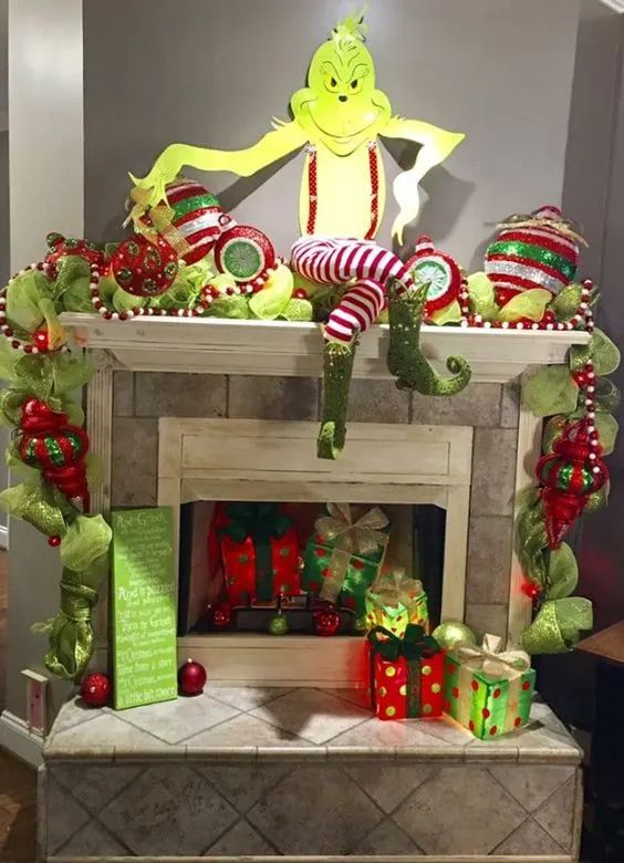 a decorated fireplace with grin the cat sitting on top