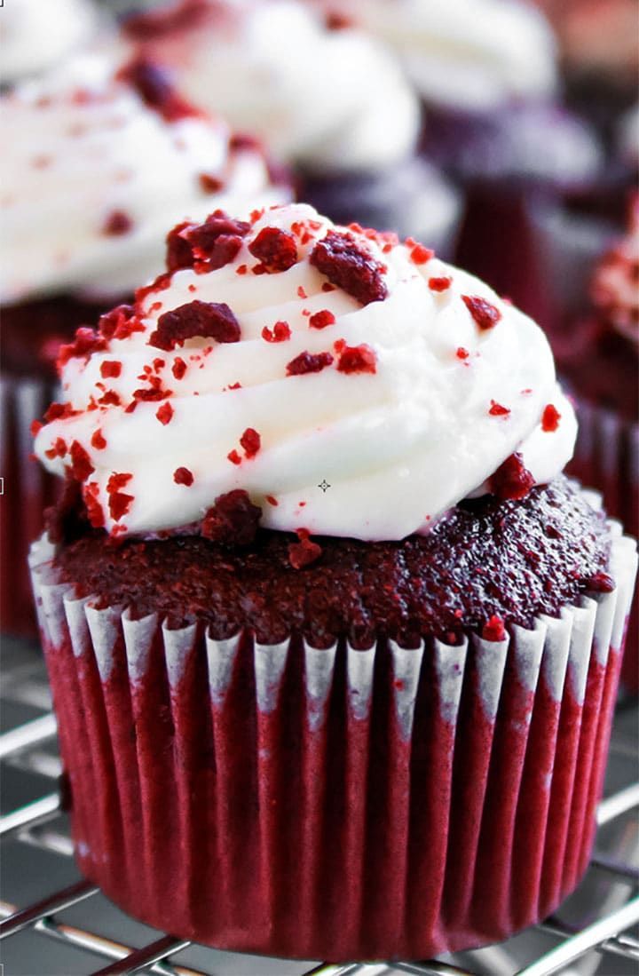 red velvet cupcakes with white frosting and sprinkles on top