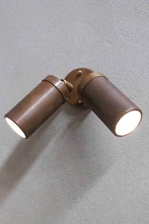 a close up of a wall light on a white wall with grey walls in the background