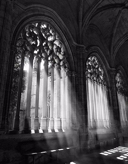 sunlight streams through the windows in an old cathedral