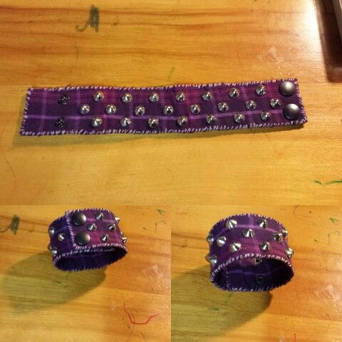 two pieces of purple fabric with silver beads on them sitting on top of a wooden table