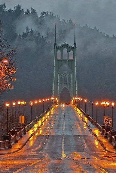 an image of a bridge that is lit up in the rain with candles on it