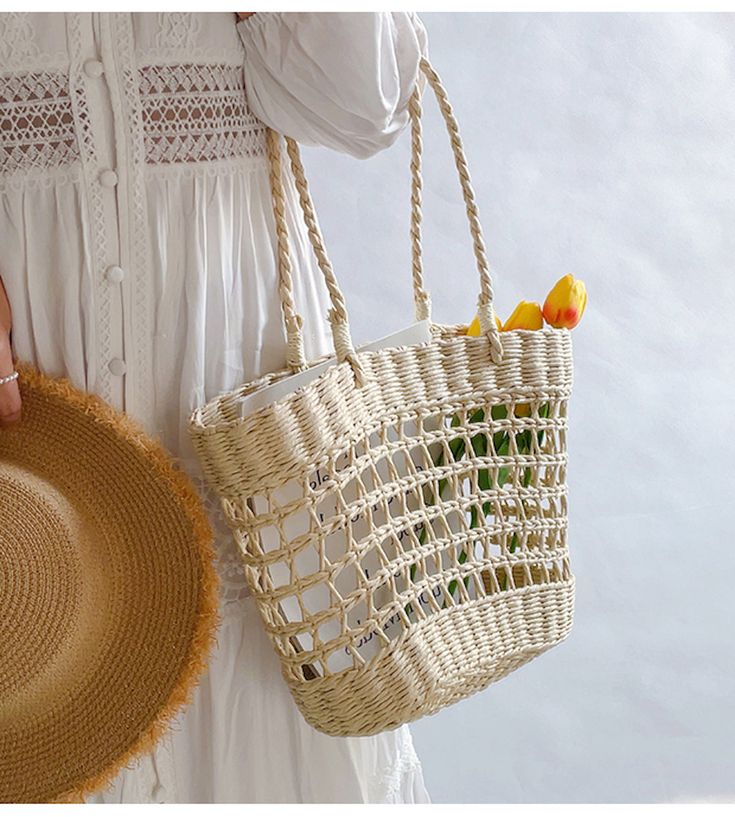 An artisanal basket of hand-woven straw basket bag. Perfect for this summer! Shoulder or top handle carry. Its light weight and durable construction make it ideal for carrying items for a day at the beach or a special event. Show off your style and make a statement with this unique tote bag. Size: 37cm wide opening x 25cm tall (14in x 10in) Designer Style ID: 8439 Eco-friendly Open Weave Straw Bag For Summer, Casual Summer Braided Bucket Bag, Casual Braided Bucket Bag For Summer, White Bohemian Open Weave Straw Bag, Casual Braided Straw Bucket Bag, Casual Natural Color Basket Bucket Bag, Casual Natural Color Basket-shaped Bucket Bag, Casual Natural Basket-shaped Bucket Bag, Casual Straw Basket Bag With Braided Handles