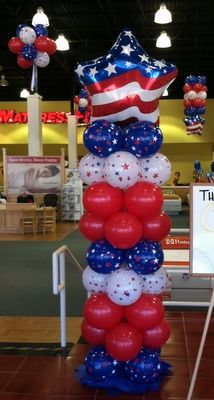 an american flag balloon tower in a store