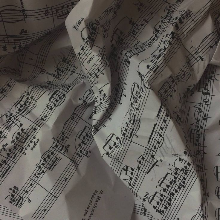 sheet music sheets with musical notes on them are crumpled in half and scattered around the edges