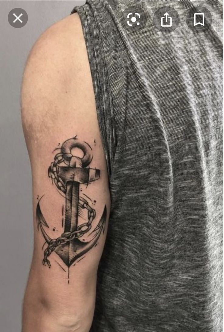 a man with a tattoo on his arm and an anchor in the middle of it